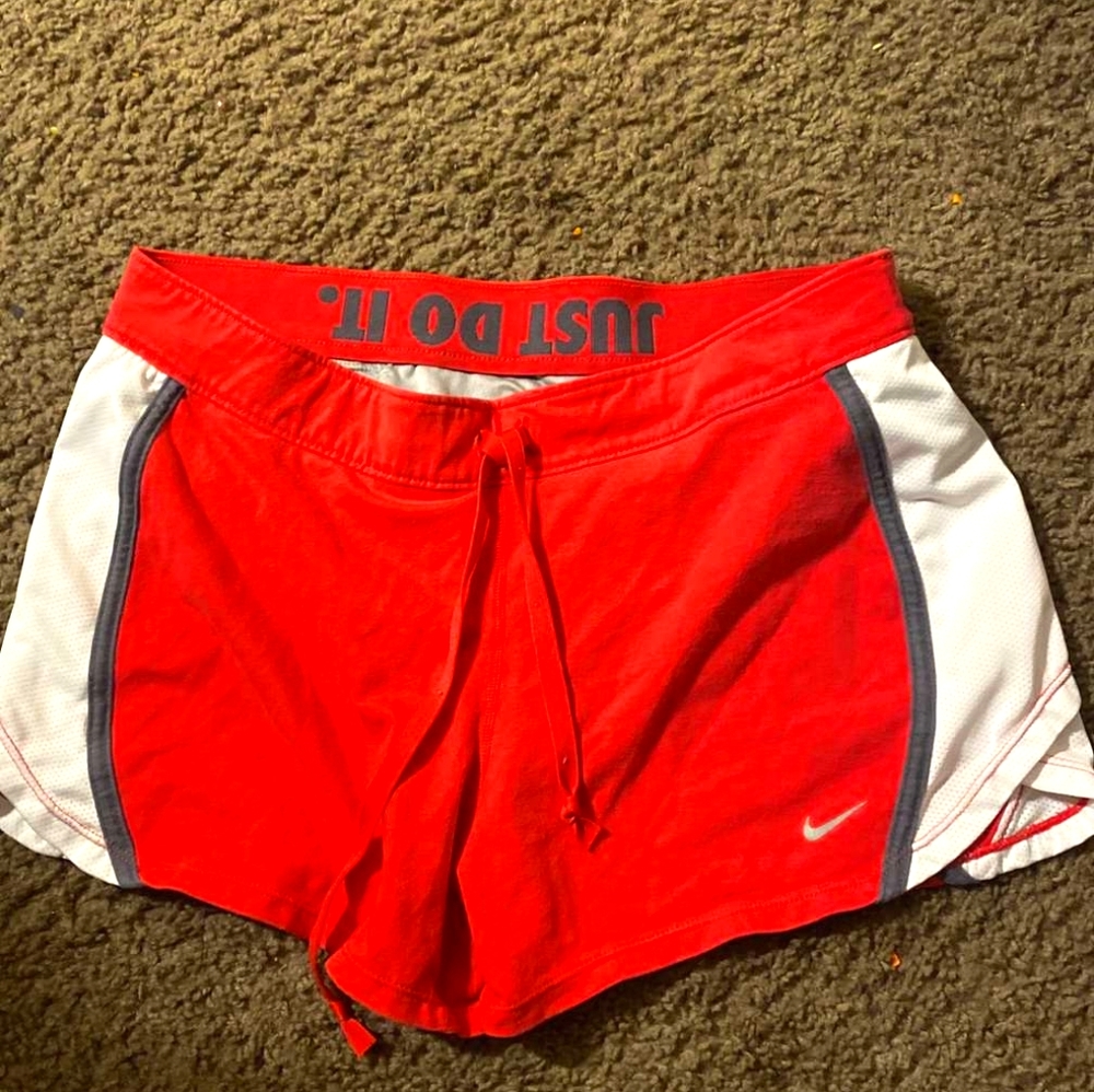 Pink and white women Nike running shorts